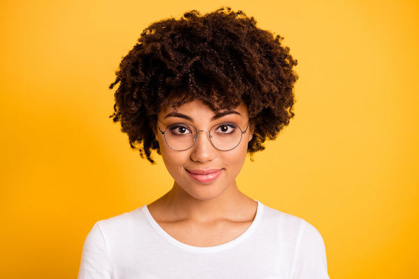 A young woman with glasses looking at the camera