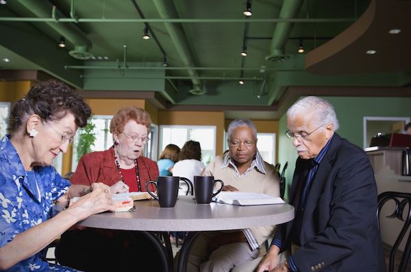 Four elderly people around a table