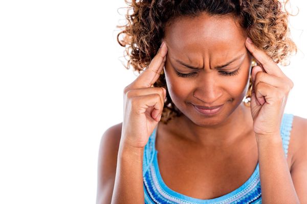 A woman holding her head in pain